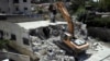 Israeli authorities demolish a Palestinian owned house in east Jerusalem, Aug. 21, 2019.