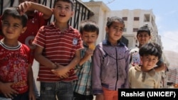 Syrian boys at camp for displaced in Aleppo