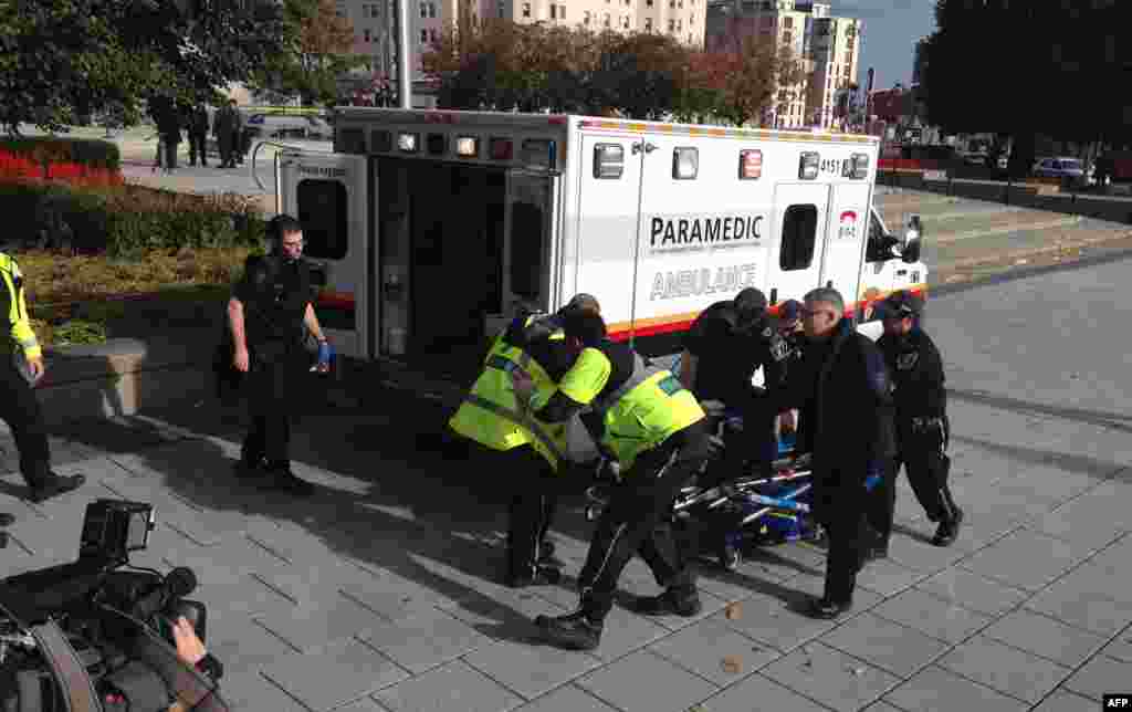 Police and paramedics transport a wounded Canadian soldier in Ottawa. 