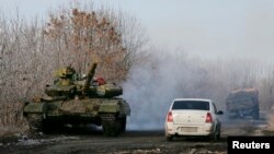 A pro-Russian separatists tank is seen on a road near the village of Rozsypne, eastern Ukraine, Dec. 15, 2014.