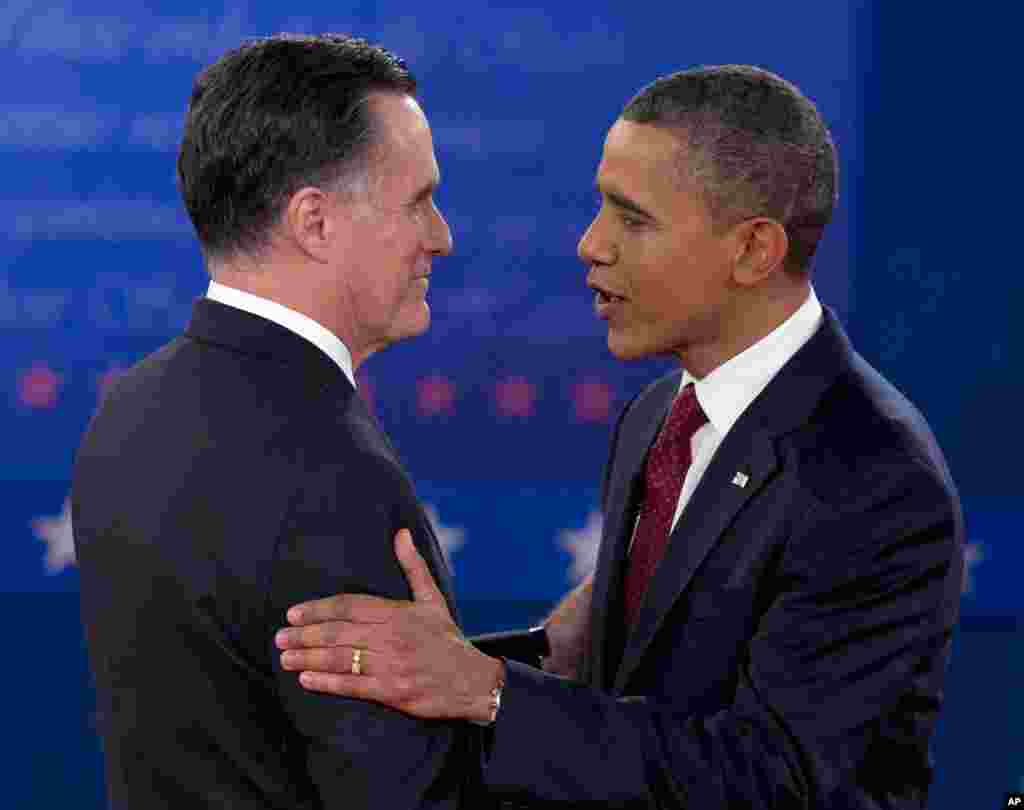 President Barack Obama and Republican presidential candidate Mitt Romney greet each other as they arrive for the presidential debate, October 16, 2012.