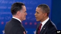 President Barack Obama and Republican presidential candidate Mitt Romney greet each other as they arrive for the presidential debate, October 16, 2012.