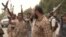 This image grab taken from a AFPTV video shows Yemeni pro-government forces gathering at the south of Hodeida airport, in Yemen's Hodeida province, June 15, 2018. 