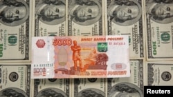 FILE PHOTO: A picture illustration shows U.S. Dollar and Russian Ruble banknotes in Sarajevo