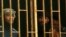 Prisoners are seen behind bars in a Benghazi jail in this February 22, 2012, file photo.