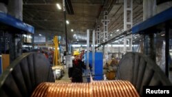 FILE PHOTO: A worker checks copper cables being produced at a factory in the central Anatolian city of Kayseri