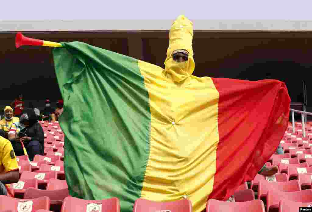 A Mali fan wears a costume in the stands.