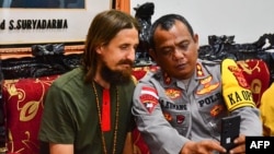 This photo taken and released Sept. 21, 2024, by the Cartenz Peace Task Force shows New Zealand pilot Phillip Mehrtens, left, following his release at a press conference in Timika. 