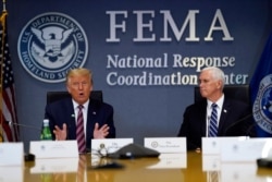 President Donald Trump speaks during a Hurricane Laura briefing at FEMA headquarters, Aug. 27, 2020, in Washington. Vice President Mike Pence listens at right.