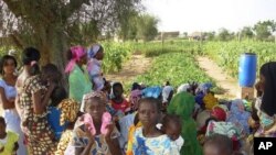 Children and women inside garden at the Wendou Bosseabe refugee camp, Senegal, October 26, 2011.