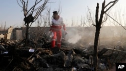 A rescue worker searches the scene where an Ukrainian plane crashed in Shahedshahr, southwest of the capital Tehran, Iran, Wednesday, Jan. 8, 2020.
(AP Photo/Ebrahim Noroozi)