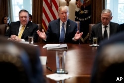 Secretary of State Mike Pompeo, left, and Secretary of Defense Jim Mattis, right, listen as President Donald Trump speaks during a Cabinet meeting at the White House, June 21, 2018, in Washington.