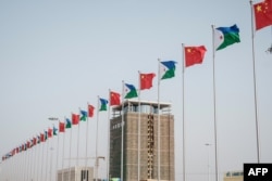 FILE - National flags of China and Djibouti are seen in front of Djibouti International Free-Trade Zone before the inauguration ceremony in Djibouti, July 5, 2018.