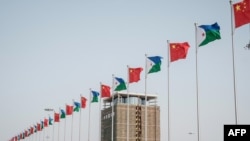 FILE - National flags of China and Djibouti are seen in front of the Djibouti International Free Trade Zone before its inauguration, in Djibouti, July 5, 2018.