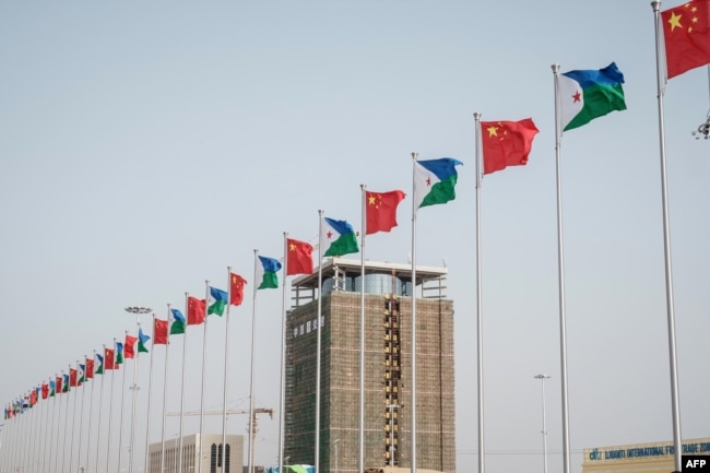 FILE - National flags of China and Djibouti are seen in front of Djibouti International Free Trade Zone (DIFTZ) before the inauguration ceremony in Djibouti, July 5, 2018.