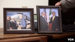 Nogales, Arizona mayor John Doyle displays a photo taken of himself and his Nogales, Mexico counterpart in his office. To the left is a photo taken with U.S. Secretary of Homeland Security John Kelly. (Photo: R. Taylor/VOA)
