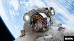 Pictured here with Earth in the background, NASA astronaut Mike Hopkins, Expedition 38 Flight Engineer, takes a spacewalk, December 2013. (Image Credit: NASA) 