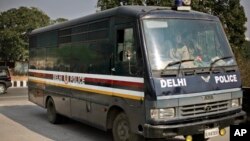 A police van carrying five of the six men accused in the gang rape and murder of a 23-year-old woman enters a district court in New Delhi, India, January 24, 2013. 