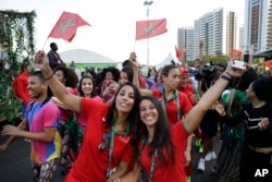 Moroccans Rizlan Kaida Zouak, a judo competitor, left, and Hind Jamili, a canoeist, celebrate at a welcoming ceremony at the 2016 Summer Olympics in Rio de Janeiro, Brazil, Aug. 4, 2016.