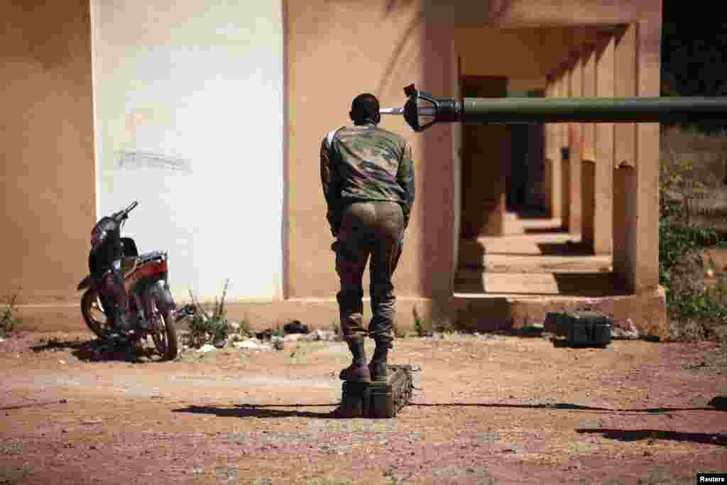 A French soldier peers into the barrel of a tank at a Malian air base in Bamako. France hit Islamist rebels in Mali with fresh air strikes and deployed armored cars, stepping up its intervention in the West African state as regional allies struggled to accelerate their plans to send in troops.