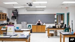 Pinon High School science teacher James Gustafson teaches virtually from his empty classroom in Pinon, Ariz., on Sept. 24, 2020. (Megan Marples/Cronkite News via AP)