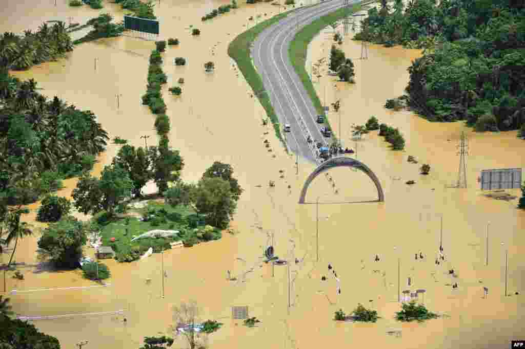 In this photograph released by the Sri Lankan Air Force Media division, flooding is seen in the country&#39;s Matara district. Heavy monsoon rains in Sri Lanka triggered flooding and landslides that killed at least 91 people and left another 110 missing, authorities said.