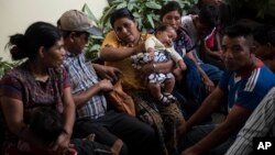 Families wait to be reunited with their children who were separated from them by U.S. immigration authorities, at the shelter "Nuestras Raíces" in Guatemala City, Tuesday, Aug. 7, 2018. 