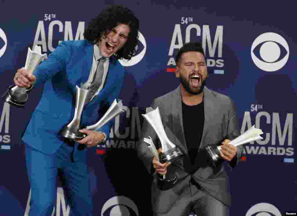 Dan + Shay pose backstage with their awards for Duo of The Year award, Single of The Year and Song of The Year for Tequila during the 54th Academy of Country Music Awards in Las Vegas, Nevada, April 7, 2019.