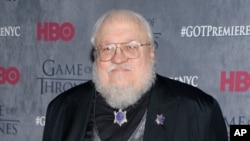 FILE - George R. R. Martin, pictured in 2014 at HBO's "Game of Thrones" fourth-season premiere in New York, writes in his blog that the sixth novel in the series is "not done. ... I tried, I promise you. I failed.''