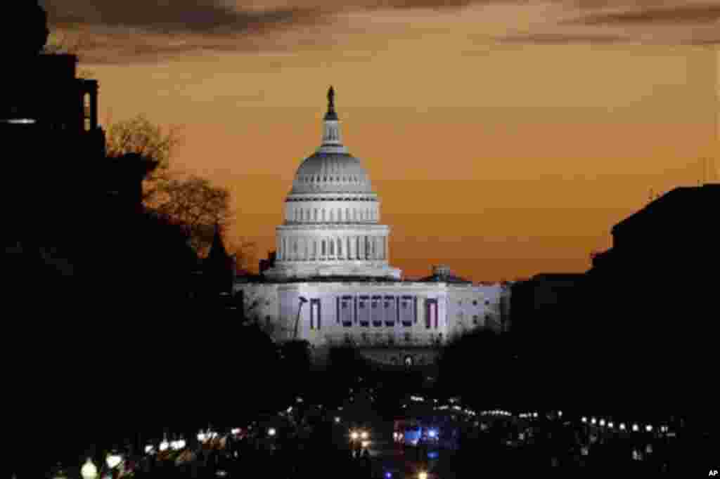 The sun rises over Capitol Hill looking down Pennsylvania Avenue in Washington, Monday, Jan. 21, 2013, as Washington prepares for the 57th Presidential Inaugural and the ceremonial swearing-in of President Barack Obama's second term. (AP Photo/Alex Brando