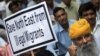 FILE - An Indian supporter of the Bharatiya Janata Party (BJP) holds a placard during a protest against what participants say is the illegal migration of Muslims from Bangladesh to the northeastern state of Assam, in New Delhi, India, Aug. 18, 2012.