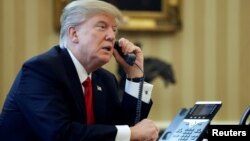 FILE - U.S. President Donald Trump speaks by phone in the Oval Office at the White House in Washington, Jan. 29, 2017.