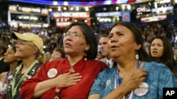 FILE: Native American delegates from Washington state listen to the national anthem, sung in the traditional Tohono O'odham language, during the Democratic National Convention in Boston, Tuesday, July 27, 2004. 