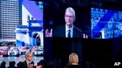 Apple CEO Tim Cook, lower left, speaks at the Bloomberg Global Business Forum, Sept. 20, 2017, in New York.
