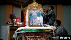 Tibetans arrange a portrait of the Dalai Lama during a function organized to mark his 82nd birthday in Lalitpur, Nepal, July 6, 2017. 