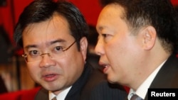 FILE - Nguyen Thanh Nghi, left, pictured with Vietnamese Vice Minister of National Resources and Environment Tran Hong Ha in 2011, has become one of the youngest provincial party chiefs in Vietnam at age 39.