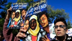 FILE - Abdul Hadi from Pakistan, joins muslim and civil rights groups and their supporters gather at a rally in front of the White House in Washington, Oct. 18, 2017. 