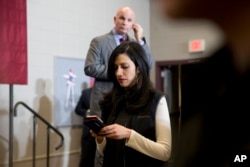 FILE - Huma Abedin, center, aide to Democratic presidential candidate Hillary Clinton is photographed during a campaign event at the Keokuk Middle School. A conservative group called Judicial Watch said in court filings it wants to question top Clinton ai