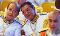 FILE PHOTO -Cambodian Prime Minister Hun Sen, center, chats with opposition leader Prince Norodom Ranariddh, left, during a blessing ceremony at the Royal Palace Friday, Oct. 29, 2004, in Phnom Penh, for King Norodom Sihamoni. (AP Photo/David Longstreath)