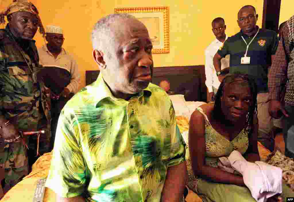 April 11: Former Ivorian President Laurent Gbagbo and his wife Simone, in the custody of forces loyal to Alassane Ouattara at the Golf Hotel in Abidjan, Ivory Coast. Forces stormed the bunker and arrested Gbagbo, whose refusal to hand over the presidency
