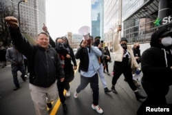 People react following the verdict in the trial of former Minneapolis police officer Derek Chauvin, found guilty of the death of George Floyd, outside the Hennepin County Government Center in Minneapolis, Minnesota, U.S., April 20, 2021. REUTERS/Nicholas