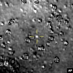 FILE - This composite image made available by NASA shows the Kuiper Belt object nicknamed "Ultima Thule," indicated by the crosshairs at center, with stars surrounding it on Aug. 16, 2018, made by the New Horizons spacecraft.
