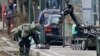 پلیس بلژیک در حال خنثی کردن یک جلیقه انفجاری یافت شده در جریان عملیاتی در محله شائربیک بروکسل - ۶ فروردین ۱۳۹۵ 