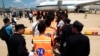 资料照片: 2017年10月12日柬埔寨金边国际机场: 因涉嫌网络诈骗而被捕的中国公民被驱逐回中国之前排队
