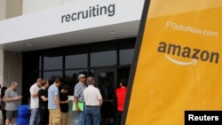 Job seekers line up to apply during "Amazon Jobs Day," a job fair being held at 10 fulfillment centers across the United States aimed at filling more than 50,000 jobs, at the Amazon.com Fulfillment Center in Fall River, Massachusetts, Aug. 2, 2017. 