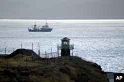 ** FILE ** Russian borderguards tower seen on Kunashir Island, one of the disputed Kuril Islands that are claimed by both Japan and Russia, in this November, 2005 file photo. A Russian patrol boat opened fire on a Japanese vessel in disputed waters Wednes