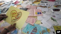 An activist checks letters written from children in the U.S. on board the Gaza-bound "Audacity of Hope" ship at Perama port near Athens, June 30, 2011