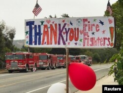 A hand-drawn sign shows thanks to firefighters heading out to tackle the Whittier Fire near Santa Barbara, Calif., July 13, 2017.