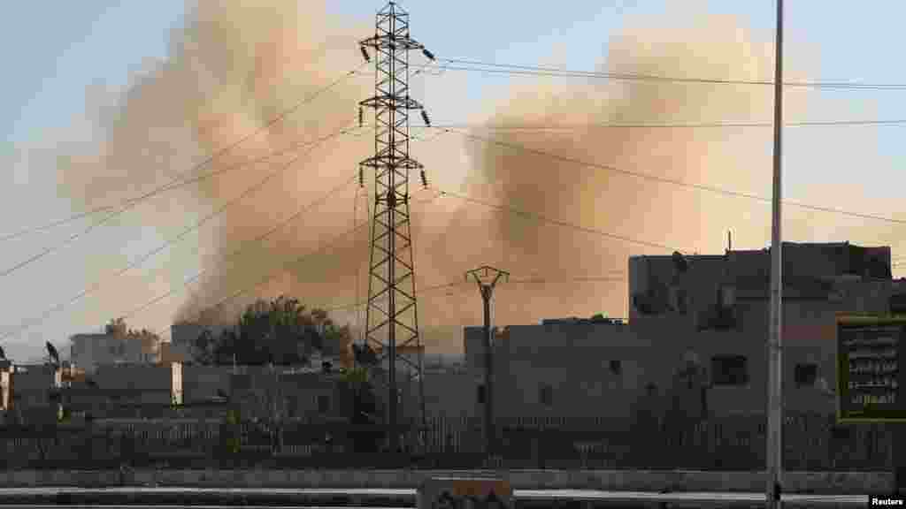 Smoke rises at a site hit by what activists said was a barrel bomb dropped by forces loyal to Syria's President Bashar al-Assad in Aleppo, Feb. 12, 2014.