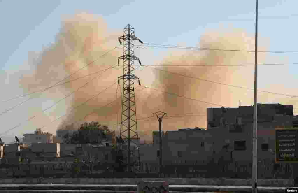 Smoke rises at a site hit by what activists said was a barrel bomb dropped by forces loyal to Syria's President Bashar al-Assad in Aleppo, Feb. 12, 2014.